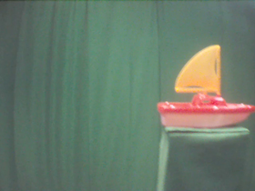 270 Degrees _ Picture 9 _ Red and Yellow Toy Sailboat.png
